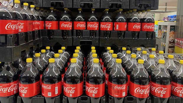 yellow cap Coca-Cola bottles